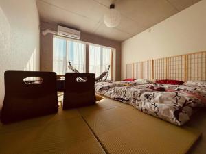 a bedroom with a bed and a large window at ShibuyaYoyogi Shinjuku 8psn 70sqm New Apartment Maisonette in Tokyo