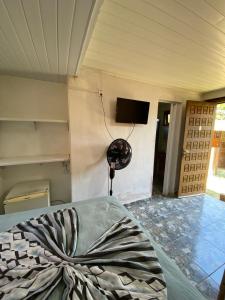 a room with a bed and a tv on a wall at Pousada Margareth in Ilha do Mel +78 photos