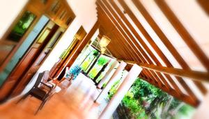 a room with a staircase with chairs and windows at Ella, Nine Arch Holiday Resort in Ella