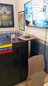 a table and a chair with a cake on it at Humacao Guest House 2 in Humacao