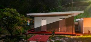 a small house in the middle of a garden at Taria Camping in Te-Fare-Arii +6 photos