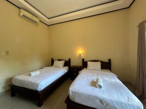 Ένα ή περισσότερα κρεβάτια σε δωμάτιο στο Pucuk Bali Guest House Canggu