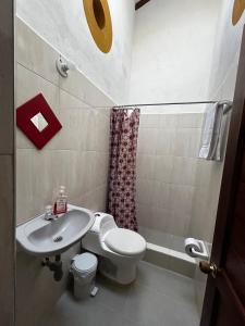 a bathroom with a toilet and a sink at Casa del Viajero in Villa de Leyva +3 photos
