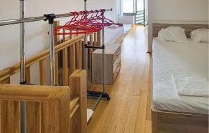 a room with two beds and a rack withuminguming at 1 Bedroom Nice Home In Tisno in Tisno