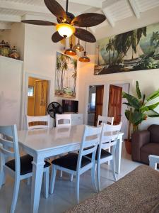 a dining room with a white table and chairs at Caye Caulker Boutique Guesthouse in Caye Caulker