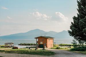 a small building on the side of a body of water at Jared's Wild Rose Ranch Resort in Lake