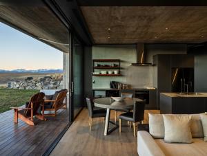 a kitchen and living room with a table and chairs at Bunker House in Lake Tekapo