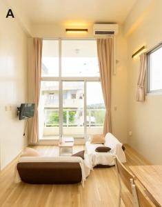 a room with two beds and a large window at MOTOBU Hills DUPLEX in Motobu