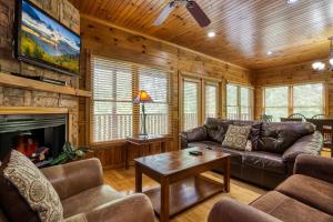 a living room with a couch and a fireplace at Mountain Charm- Hot Tub, Game Room, Theater Room, free Attraction Tickets!!! in Sevierville