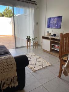 圣罗莎Departamento Urquiza II的带沙发和电视的客厅