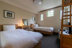 Fujiyama Inn Coniferにあるベッド