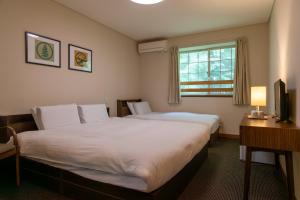 Fujiyama Inn Coniferにあるベッド