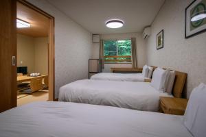 Fujiyama Inn Coniferにあるベッド