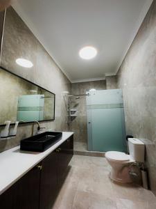 a bathroom with a toilet and a sink and a shower at Jasmine in Taraz
