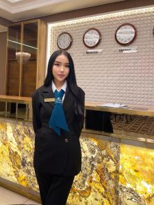 a woman wearing a uniform with a blue bow tie at Jasmine in Taraz