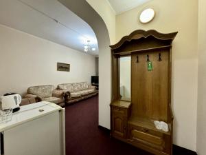 a living room with a couch and a wooden door at Hotel Zhambyl in Taraz