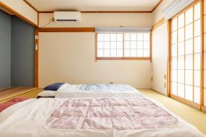 Ένα ή περισσότερα κρεβάτια σε δωμάτιο στο 池袋駅まで徒歩15分 畳の家