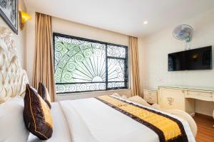 Postel nebo postele na pokoji v ubytování Golden Star Hotel