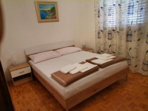a bedroom with a bed with two towels on it at Apartman Jadranka in Novi Vinodolski