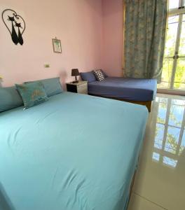Postel nebo postele na pokoji v ubytování 豐綠民宿 Yilan Fenglu Homestay