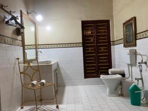 a bathroom with a toilet and a sink and a mirror at Bhairon villas in Bikaner