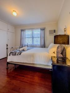 a bedroom with a large bed and a window at RetroRhapsody in Gold Coast