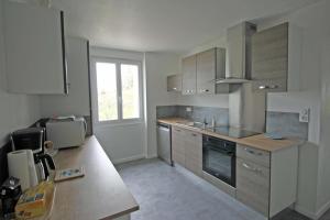 a kitchen with stainless steel appliances and a counter top at Le monteil in Saint-Sornin-Leulac