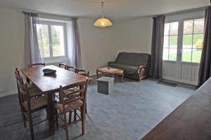 a living room with a table and chairs and a couch at Le monteil in Saint-Sornin-Leulac +7 photos