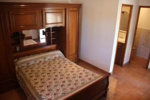 a bedroom with a bed with a wooden frame at La maison d'hôtes des ferrages in Tavernes