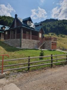 a house on a hill with a fence in front of it at Golden Eagle Jelovica in Berane