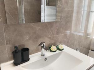 a bathroom sink with a faucet and a mirror at 1920 Classic in Kalamata +79 photos