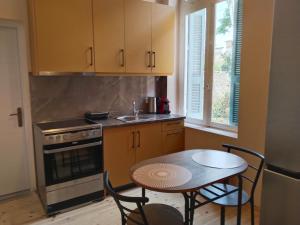 a kitchen with a table and a sink and a stove at 1920 Classic in Kalamata