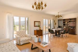 a living room with a table and a dining room at G&S Family Resort in Argostoli