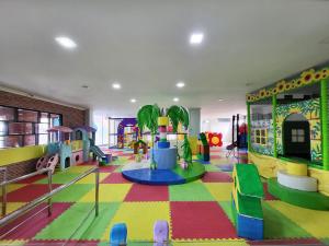 a childrens play area with a playground with a slide at Grand Bayu Hill Hotel in Takengon