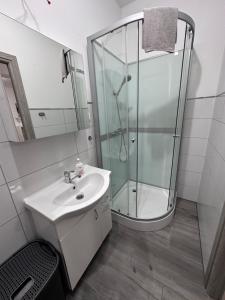 a bathroom with a glass shower and a sink at Apartament Szczecinek in Szczecinek