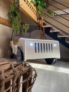 a white jeep parked in a room with stairs at Serengeti Safari Room in Sigean +53 photos
