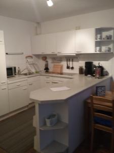 a kitchen with white cabinets and a counter top at Ferienwohnung im Kapitänsgarten in Prerow in Prerow