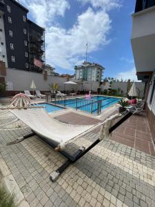 a swimming pool with a hammock on top of a building at kestel city 1 in Alanya