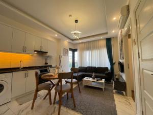 a kitchen and living room with a table and chairs at kestel city 1 in Alanya