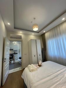 a bedroom with a white bed with towels on it at kestel city 1 in Alanya +20 photos