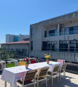 a table and chairs on the roof of a building at Marald Eforie Nord in Eforie Nord
