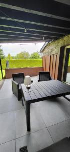 a wooden table and chairs on a patio at L'Essentiel à Francorchamps in Francorchamps