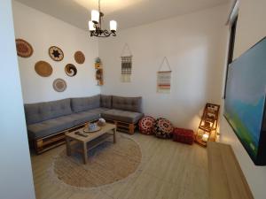 a living room with a couch and a table at Cozy Apt in amman with a view in Amman