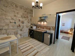a kitchen with a table and a stove top oven at Cozy Apt in amman with a view in Amman