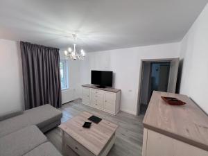 a living room with a couch and a flat screen tv at Casa Paraiso Constanta City in Constanţa