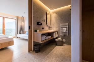 łazienka z umywalką i lustrem w obiekcie Kronplatz-Resort Hotel Kristall w mieście Valdaora