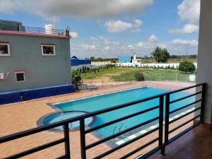 a swimming pool on the balcony of a house at Shivanta Resort and Hotel in Deoghar