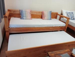 Postel nebo postele na pokoji v ubytování Solana Siargao