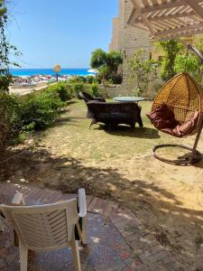 a patio with two chairs and a table and a bench at Chalet for Rent, Ground Floor in Zamorda Village with Private Garden and Sea View in Dawwār Shindī Fannūsh +4 photos