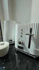 a close up of a coffee maker on a counter at GET WILD brīvdienu māja in Dzelmes +14 photos